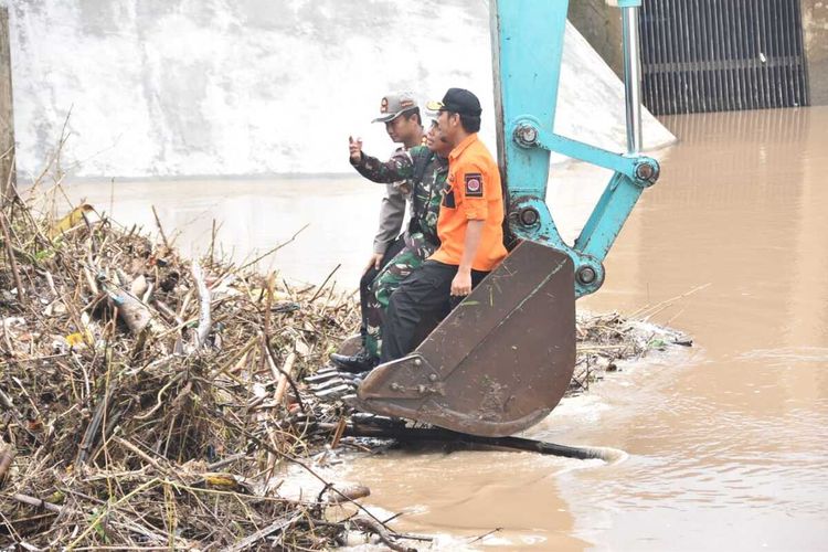 Bupati Madiun, Ahmad Dawami, Kapolres Madiun, AKBP Ruruh Wicaksono dan Dandim 0803 Madiun, Letkol CZI Nur Alam Sucipto memantau tumpukan sampah yang menyumbat pintu air 12 Desa Glonggong, Kecamatan Balerejo, Kabupaten Madiun, Rabu (7/1/2020).