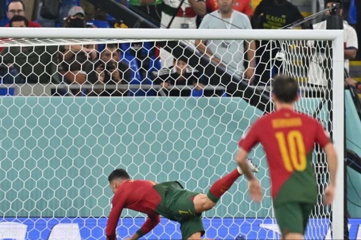 Kiper Ghana, Lawrence Ati Zigi, melakukan penyelamatan untuk menggagalkan usaha penyerang Portugal, Cristiano Ronaldo, dalam laga penyisihan Grup H Piala Dunia 2022 di Stadium 974, Doha, Kamis (24/11/2022).