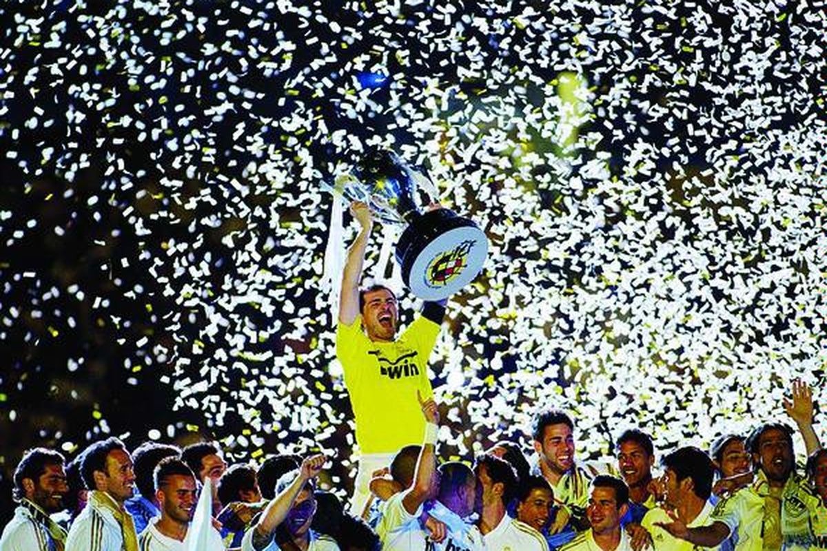 Kiper dan kapten  Real Madrid, Iker Casillas, memegang trofi Liga Spanyol dalam perayaan kesuksesan 