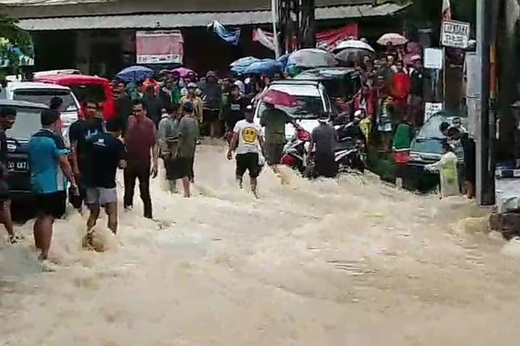 Sejumlah rumah, mobil dan fasilitas umum terendam banjir dan sebagian warga dibantu petugas mengungsi ke posko yang disediakan di sekitar lokasi, Kecamatan Cileungsi, Kabupaten Bogor, Rabu (1/1/2019).