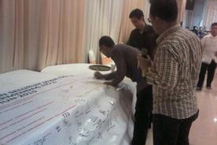 Pedagang miras eceran menandatangani petisi untuk Jokowi.