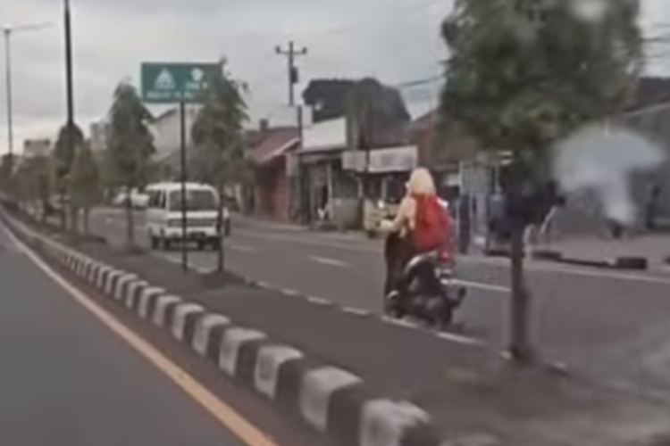 Tangkapan layar video viral yang menampilkan seorang pengendara motor yang mengenakan pakaian mirip seragam sekolah melawan arah di Jalan Jogja-Solo.