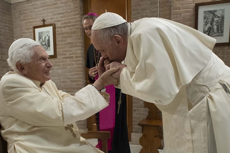 Paus Fransiskus mencium tangan mantan Paus Benediktus XVI dalam kunjungan setelah pelantikan 13 kardinal baru di Vatikan, pada Sabtu, 28 November 2020.