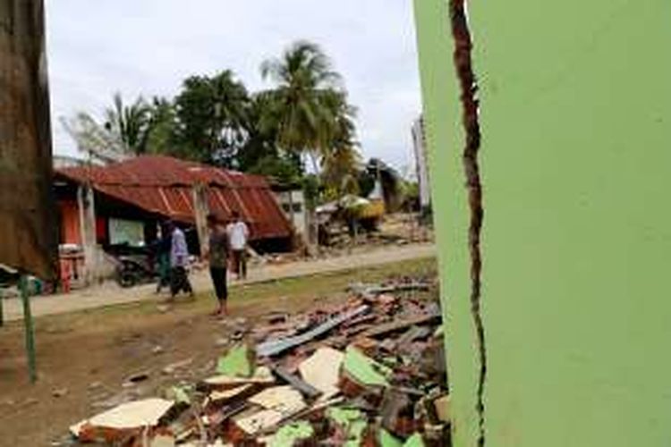 Situasi rumah yang runtuh akibat gempa di Desa Kuta Pangwa, Kecamatan Trienggadeng, Pidie Jaya, Aceh, Jumat (9/12/2016). Desa Kuta Pangwa adalah titik desa terparah dan menyebabkan puluhan rumah warga hancur dan memakan 15 orang dari 9 kepala keluarga.

