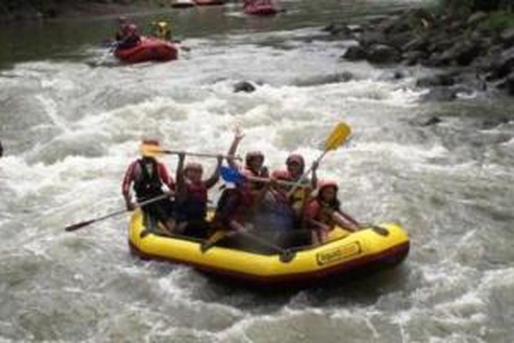 Sejumlah wisatawan tampak asyik melakukan rafting dengan perahu karet di Sungai Elo, Rabu (1/1/2014) siang. Kunjungan wisatawan di sejumlah obyek wisata di Kabupaten Magelang mengalami peningkatan cukup drastis saat liburan natal dan tahun baru kali ini.  