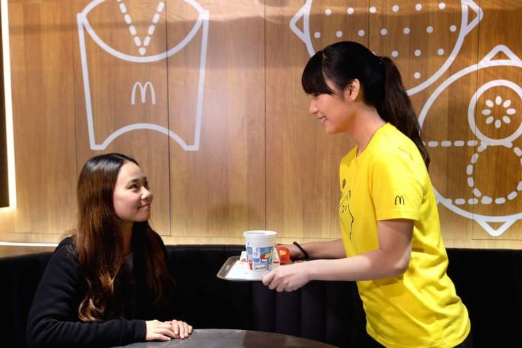Pramusaji mengantarkan makanan di McDonald's Next Hong Kong.