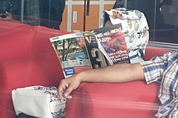 Kepala Dinas Kesehatan Provinsi Lampung, Reihana menutupi wajahnya sembari membaca majalah Venue Edisi Desember 2013, Senin (8/5/2025).