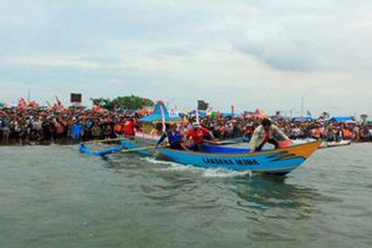 Salah satu perahu nelayan yang membawa jolen atau rumah-rumahan sesaji di Pantai Teluk Penyu yang selanjutnya akan dilarung di Pulau Majeti, sebelah selatan Pulau Nusakambangan, Cilacap, Jawa Tengah, Jumat (7/12/2012). Hal tersebut merupakan bagian dari prosesi Tradisi Sedekah Laut yang dilakukan setiap Bulan Sura sebagai ungkapan syukur nelayan atas hasil laut setahun ini dan berharap perlindungan selama setahun ke depan. Tradisi ini  melibatkan ribuan nelayan di seluruh Cilacap dan menjadi agenda pariwisata unggulan wilayah setempat. 

