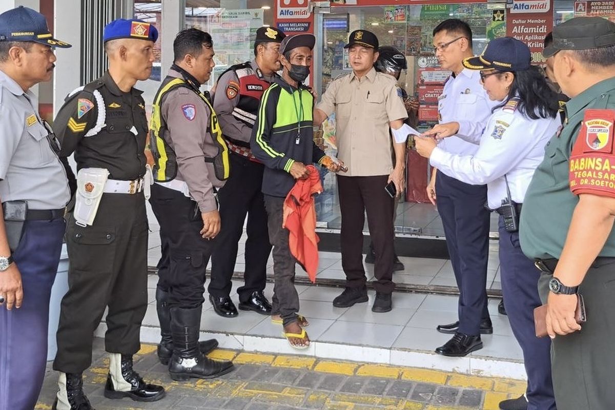 Petugas saat menindak jukir liar di toko swalayan di Surabaya, Selasa (15/4/2025).