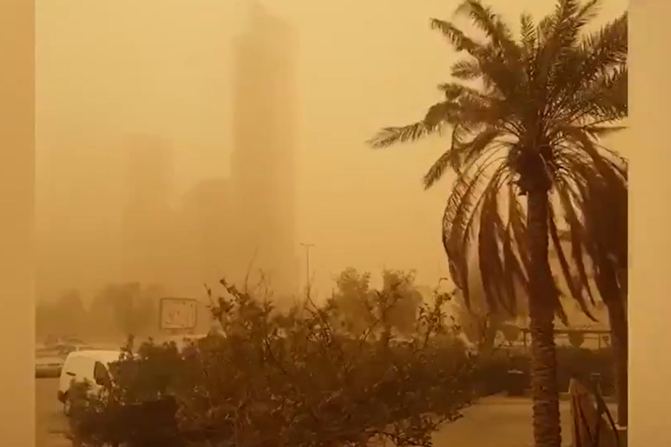 Pencakar langit di Kuwait City, Kuwait, menghilang ke langit jingga berkabut akibat badai debu besar yang menyapu kawasan itu akhir pekan lalu. 