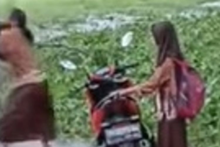 Tangkapan layar video viral seorang pria memukul dan membanting siswi di Nganjuk