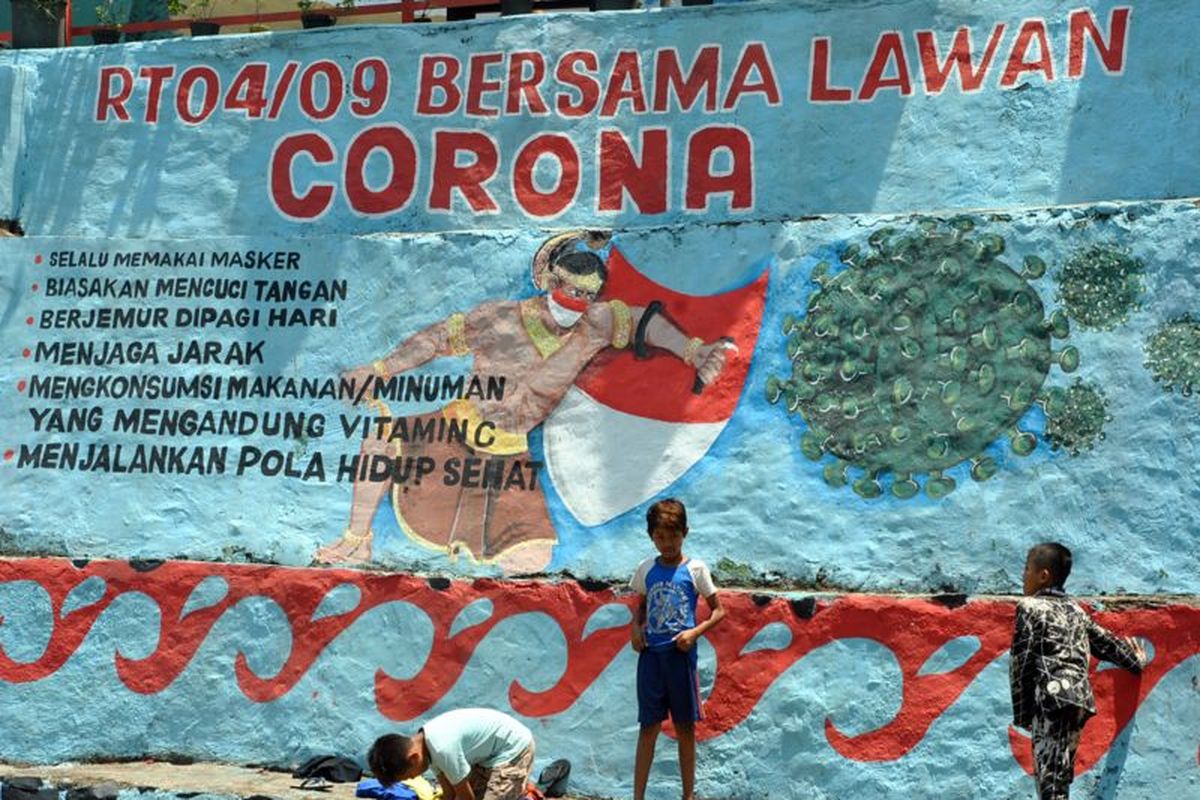 Anak-anak bermain di dekat mural tentang corona di Babakan Pasar, Kota Bogor, Jawa Barat, Kamis (17/09)