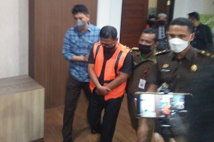 Mantan kepala UPC Pegadaian Tambak Bawean (mengenakan rompi oranye), saat dibawa petugas menuju mobil tahanan, Selasa (31/5/2022) malam.