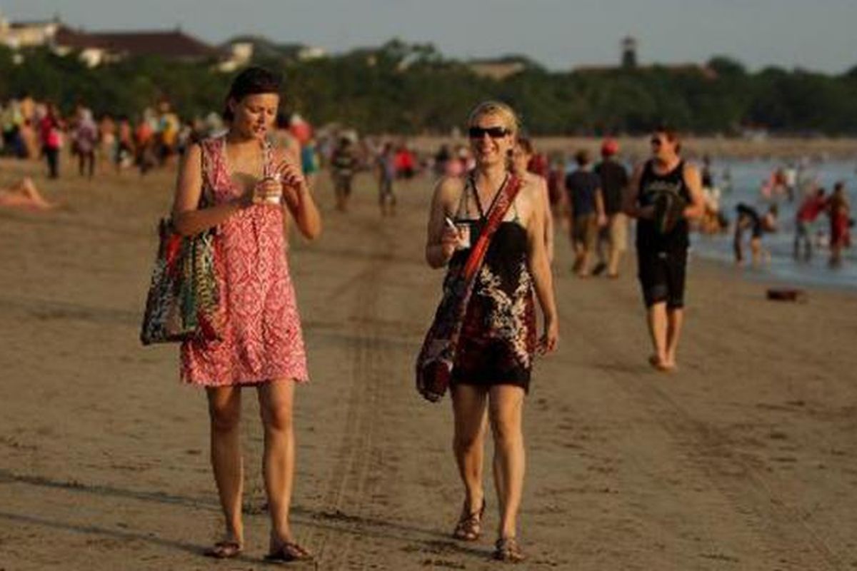 Wisatawan menikmati sore di Pantai Kuta, Bali, Sabtu (22/6/2013). Keindahan wisata pantai di sejumlah kawasan di Bali seperti Kuta, Seminyak, Jimbaran, Nusa Dua dan Tanjung Benoa masih menjadi daya tarik wisatawan baik domestik maupun mancanegara.