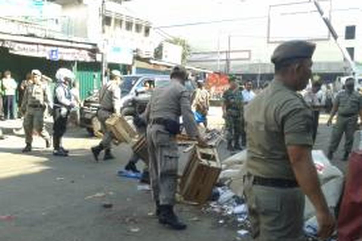 Petugas Satpol PP saat melakukan pembongkaran lapak-lapak PKL di Jalan Jembatan Tinggi, Pasar Tanah Abang, Jakarta Pusat, Minggu (11/8/2013)