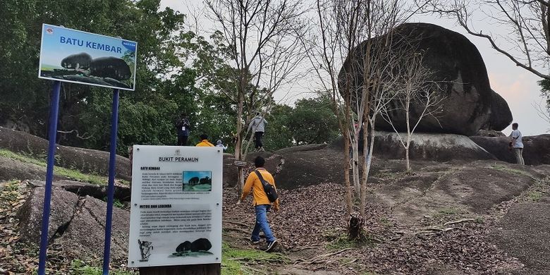 Batu Kembar, merupakan spot foto kedua yang dapat pengunjung temui di Bukit Peramun, Belitung. Konon, siapa yang bisa merentangkan kedua tangannya di kedua celah batu, akan dimudahkan jodoh dan diharmoniskan keluarganya.