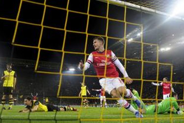Ekspresi gelandang Arsenal Aaron Ramsey setelah membobol gawang Borussia Dortmund, pada pertandingan Liga Champions, di Signal Iduna Park, Rabu (6/11/2013).