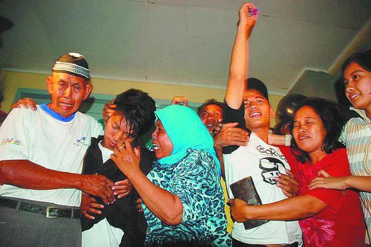 Dua dari tiga terdakwa kasus pembunuhan, Sudirman Yusuf (kedua dari kiri) dan Ibrahim Tutu (ketiga dari kanan), disambut keluarganya saat dibebaskan dari Rumah Tahanan Makassar, Jumat (5/9) malam, setelah dipenjara setahun lebih. Pembebasan itu merupakan eksekusi putusan kasasi Mahkamah Agung. 