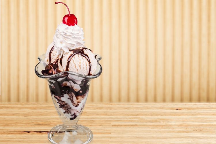 Ilustrasi ice cream sundae, es krim topping sirup cokelat dan buah ceri. 