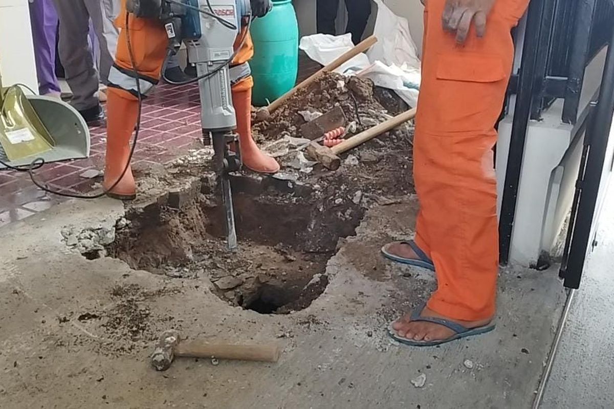 Petugas PPSU membongkar septic tank tempat kejadian perkara (TKP) klinik aborsi ilegal dengan mesin bor baja di Kemayoran, Jakarta Pusat, Senin (3/7/2023).