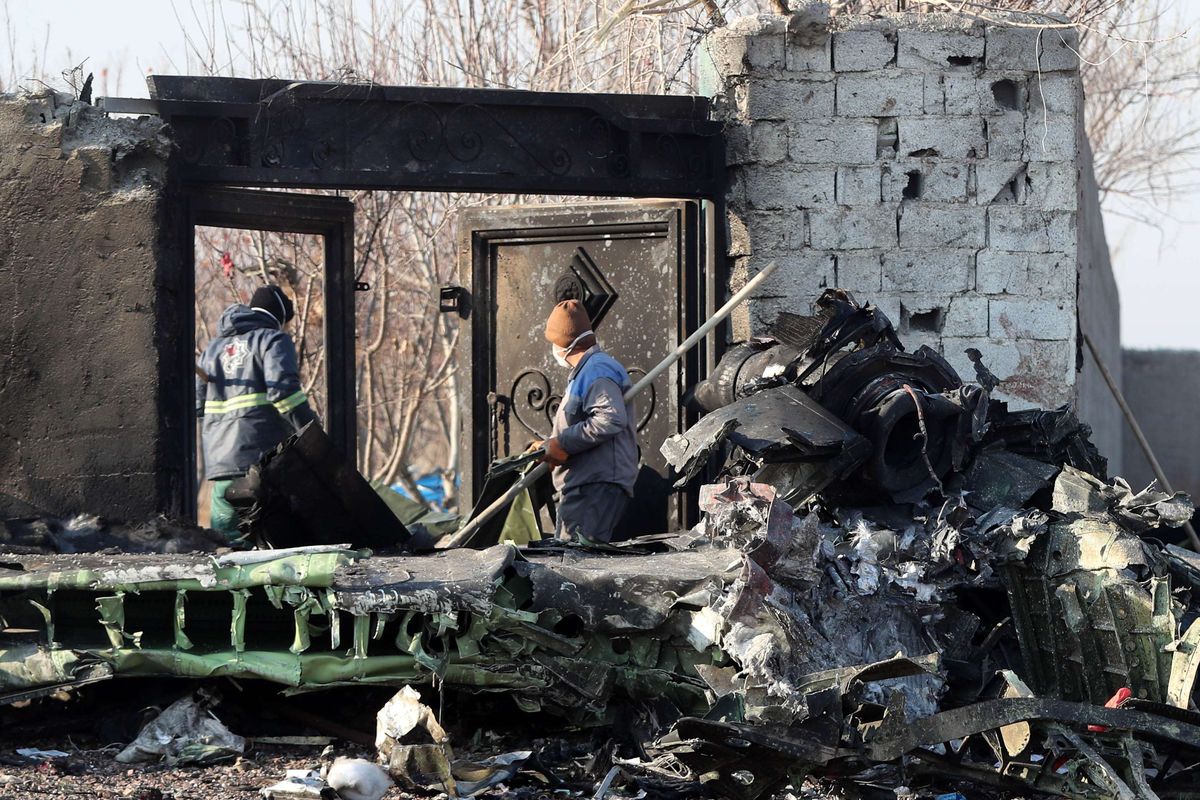 Petugas berkumpul di lokasi jatuhnya pesawat Ukraina di Parand, wilayah barat daya Teheran, Rabu (8/1/2020) pagi waktu setempat. Pesawat berjenis Boeing 737-800 itu jatuh tak lama setelah lepas landas dari Bandara Internasional Imam Khomeini, Teheran, Iran.