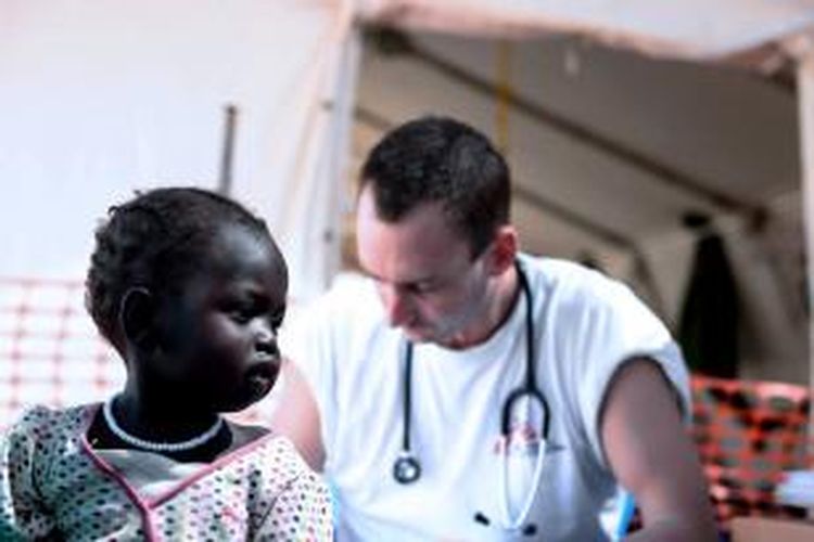 Seorang dokter dari organisasi Medecins Sans Frontieres (MSF) sedang memeriksa kondisi seorang bocah pengungsi Sudan Selatan. Belakangan, bantuan medis di Sudan Selatan terganggu karena kedua pihak mulai menjarah rumah sakit dan membunuh pasien.