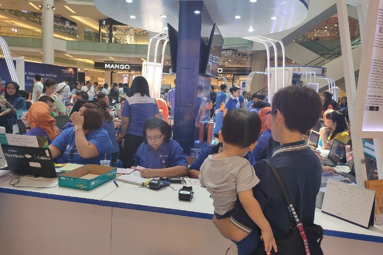 Pengunjung tengah dilayani bagian ticketing booth agen perjalanan Dwidaya Tour dalam pameran Singapore Airlines BCA Travel Fair 2020, Sabtu (15/2/2020).