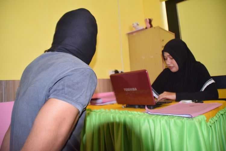 Seorang lelaki berinisial MH (menggunakan penutup kepala), warga Kota Baubau, Sulawesi Tenggara, tega mencabuli dua anak kandungnya yang masih di bawah umur. Bahkan seorang anaknya berinisial R (16), dicabuli sejak masih kelas 4 SD hingga saat ini, kelas 3 SMA.