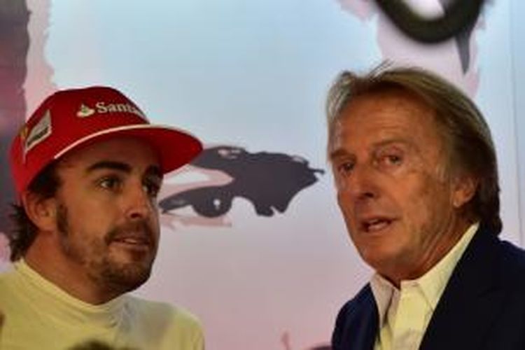 Kepala tim Ferrari, Luca di Montezemolo (kanan), berbicara dengan pebalap Ferarri asal Spanyol, Fernando Alonso, di pit Sirkuit Monza, pada sesi latihan ketiga GP Italia, Sabtu (6/9/2014).
