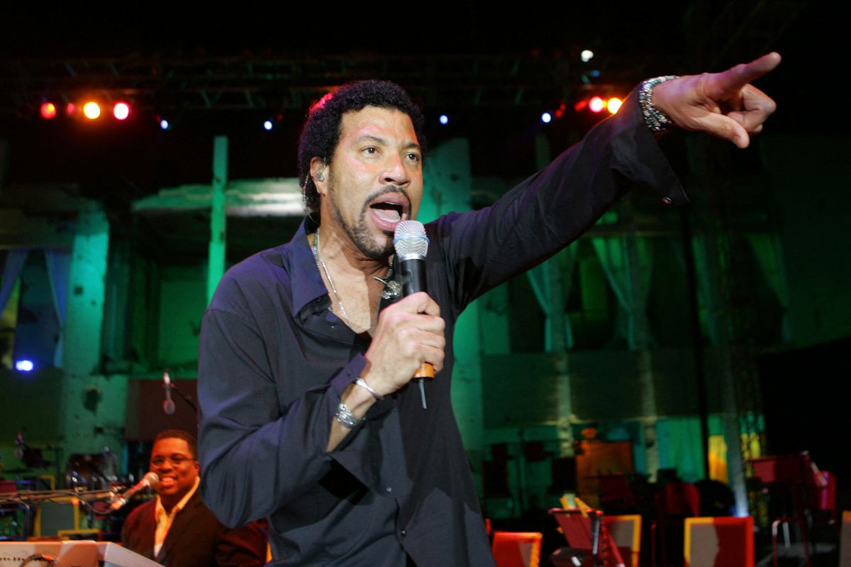 US soul singer Lionel Richie performs during a concert held in front of the house of Libyan leader Moamer Kadhafi, which was attacked 20 years ago by the United States, late 14 April 2006 in Tripoli. The commemoration is part of the Hana Festival for Freedom and Peace in remembrance of the Libyan leader's slain daughter who was killed in the attack. (Photo by KHALED DESOUKI / AFP)