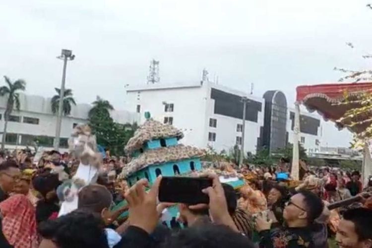 Warga Semarang, Jawa Tengah berebut roti ganjel rel saat acara Dugderan. 