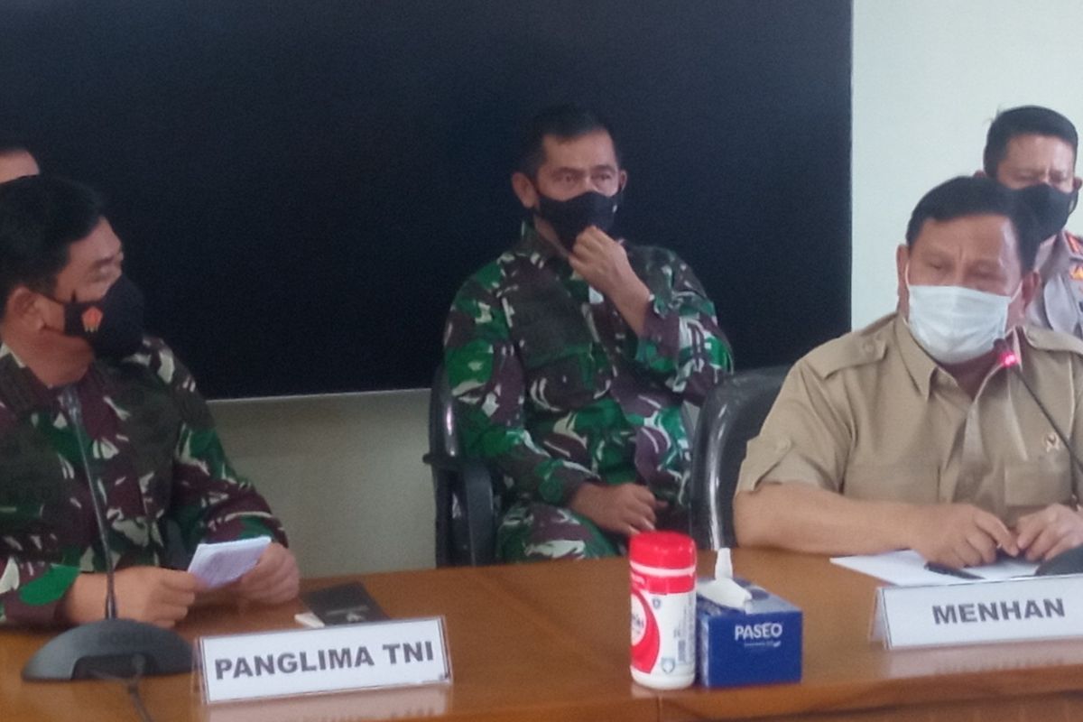 Indonesia's Military (TNI) commander Air Chief Marshal Hadi Tjahjanto (left) and Defense Minister Prabowo Subianto speak during a press conference held at I Gusti Ngurah Rai Air Force Base in Bali. 