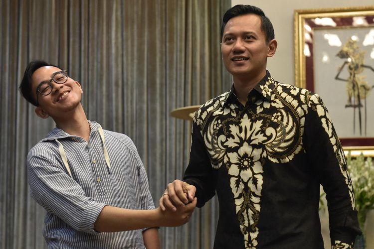 Putra Presiden Joko Widodo Gibran Rakabuming Raka (kiri) berjabat tangan dengan putra Mantan Presiden Susilo Bambang Yudhoyono Agus Harimurti Yudhoyono (kanan) usai pertemuan tertutup di Presidential Lounge, Kompleks Istana Kepresidenan, Jakarta, Kamis (10/8/2017). Kedatangan Agus Harimurti ke Istana dalam rangka menyampaikan undangan peresmian The Yudhoyono Institute.