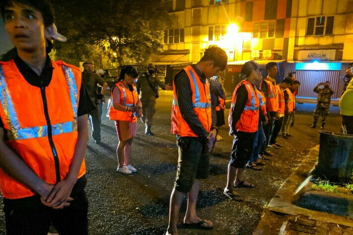 Satpol PP Tangsel memberikan sanksi kepada 12 orang yang melanggar protokol kesehatan ditengah PSBB. Mereka tidak menggunakan masker dan jaga jarak saat berkumpul disebuah rumah makan dan kafe di kawasan Serpong, Tangerang Selatan, Senin (15/6/2020) malam.