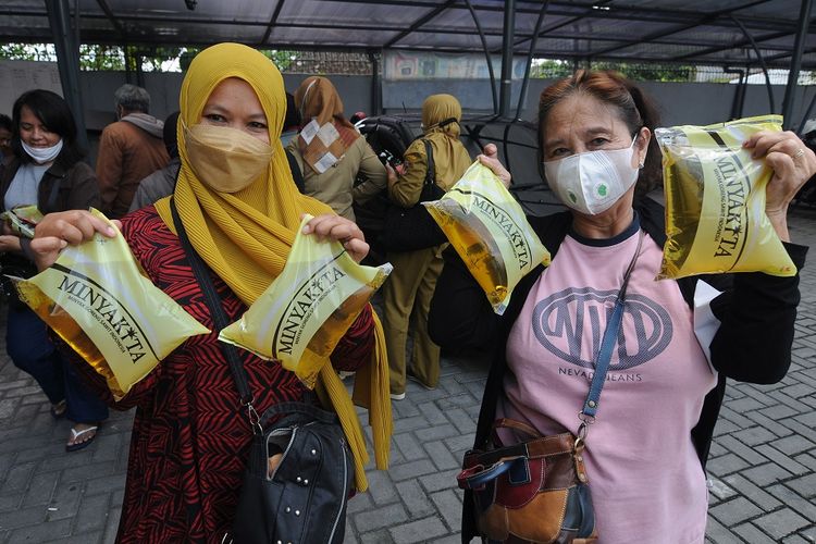 Warga menunjukkan minyak goreng yang dibeli saat pasar minyak goreng murah di Boyolali, Jawa Tengah, Senin (14/3/2022). Dinas Perdagangan dan Perindustrian Kabupaten Boyolali menggelar pasar minyak goreng murah untuk warga dengan harga jual Rp13.500 per liter dan diharapkan dapat membantu warga dalam kebutuhan minyak goreng karena di pasaran mahal dan sulit. ANTARA FOTO/Aloysius Jarot Nugroho/rwa.