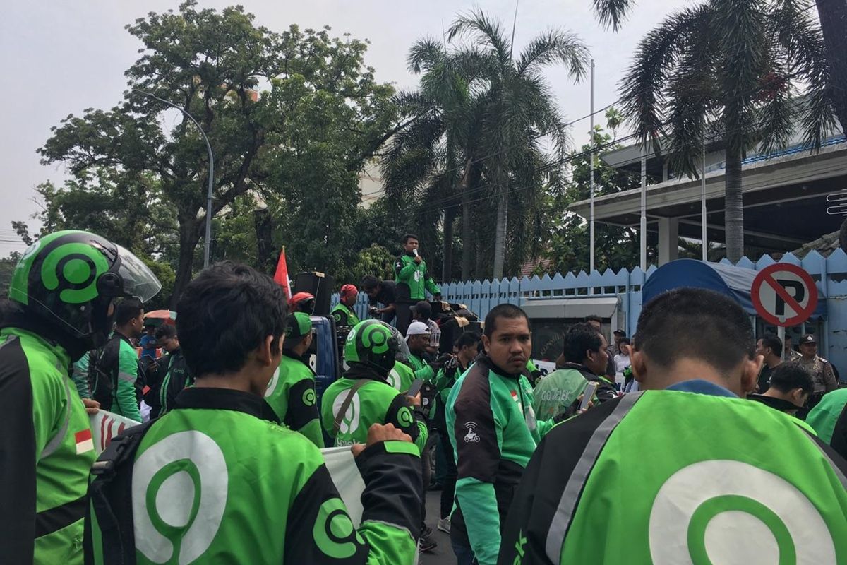 Massa aksi mengenakan jaket ojek online berunjuk rasa di depan kantor Konjen Malaysia di Jalan Diponegoro, Medan, Rabu siang (11/9/2019). Aksi mereka menuntut bos taksi di Malaysia meminta maaf kepada masyarakat Indonesia.