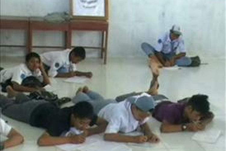 Karena sekolah tak memiliki kursi dan meja, ratusan siswa SMK Negeri 2 Mamuju Utara terpaksa belajar sambil tengkurap di lantai.