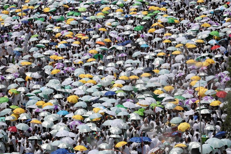 Para jemaah haji membawa payung untuk melindungi diri dari terik matahari, saat berkumpul untuk shalat di Masjid Namirah dekat Gunung Arafah, menjelang puncak ibadah haji, di Mekah, Arab Saudi, Kamis (31/8/2017). Tercatat sekitar 2,1 juta umat Muslim dari berbagai belahan dunia berkumpul untuk melaksanakan ibadah haji tahun ini.