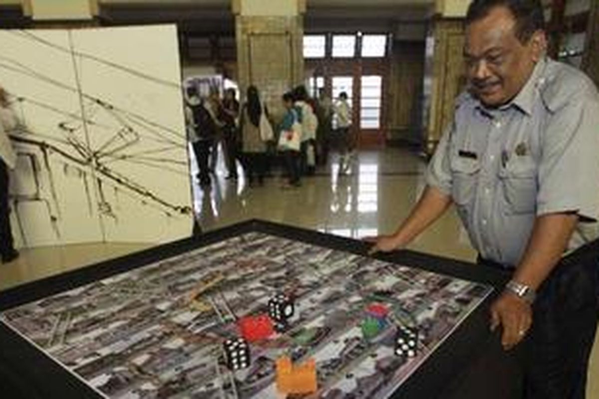 Pengunjung melihat permainan ular tangga bertema kereta api dalam pameran Perkeretaapian Indonesia Dalam Peradaban Bangsa, di Stasiun Jakarta Kota, Jakarta Barat, Selasa (19/7/2011). Pameran ini menampilkan sejarah panjang perkerertaapian di Indonesia dan perkembangannya bagi masyarakat sebagai alat transportasi.