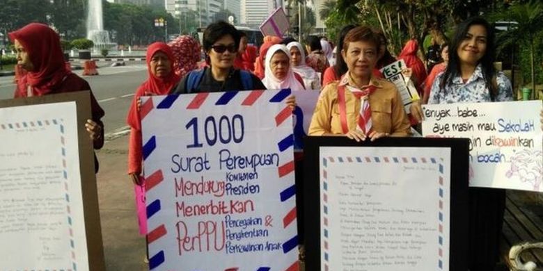 An image of some activists march along streets in Indonesia.  