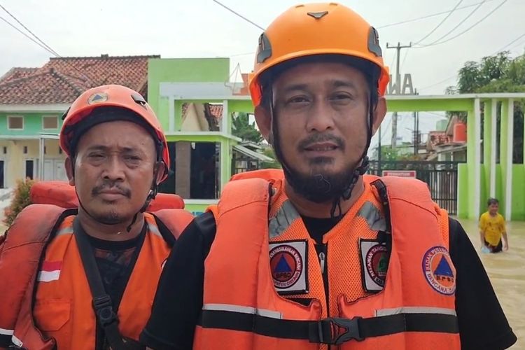 Eko Handi, Kabid Kedaruratan dan Logistik bersama Faozan tim Pusdalops BPBD Kabupaten Cirebon, memberikan keterangan terkait update penanganan banjir yang terjadi di 20 Desa di 10 Kecamatan di Kabupaten Cirebon pada Sabtu-Minggu (14/12/2025) siang.