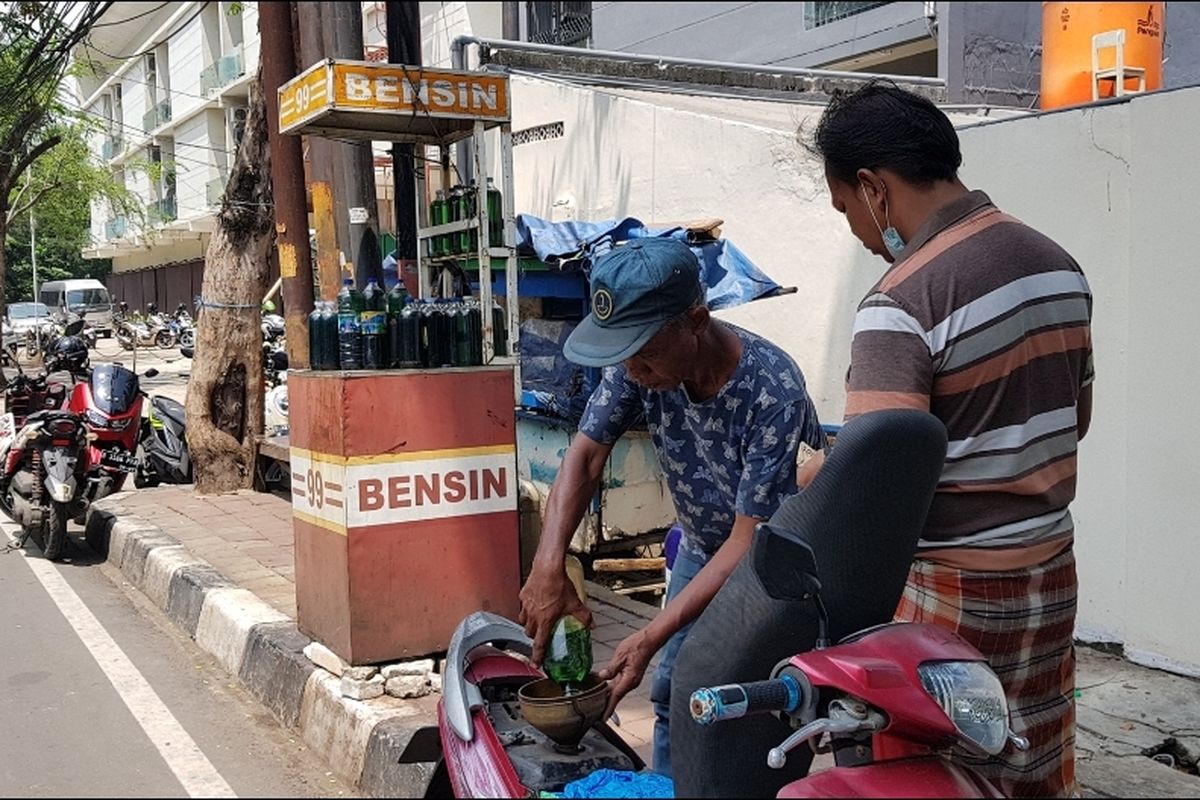 Siswo (55), seorang penjual bensin eceran di Jalan Sindang, Koja, Jakarta Utara, saat melayani pelanggannya yang membeli bahan bakar jenis Pertalite, Senin (4/4/2022).