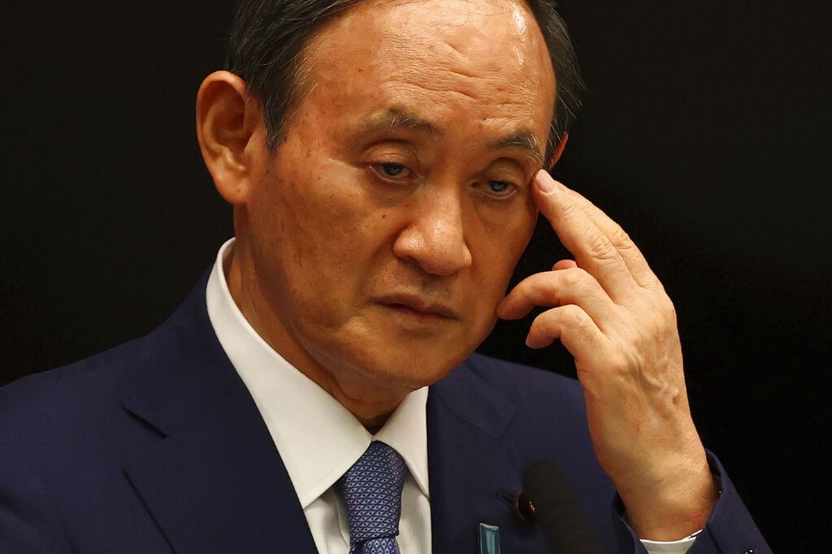 Japan's Prime Minister Yoshihide Suga attends a news conference on Japan's response to the coronavirus pandemic at his official residence during the Tokyo 2020 Olympic Games in Tokyo, Japan, Friday, July 30, 2021. Suga expanded a coronavirus state of emergency to four more areas in addition to Tokyo on Friday following record spikes in infections as the capital hosts the Olympics. (Issei Kato/Pool Photo via AP)