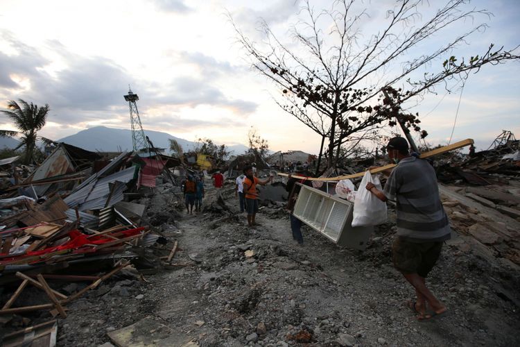 Warga korban gempa bumi menyelamatkan barang berharga yang masih bisa digunakan di Petobo, Palu, Sulawesi Tengah, Jumat (5/10/2018). Petobo menjadi salah satu wilayah yang paling parah terdampak gempa karena dilalui sesar Palu Koro.