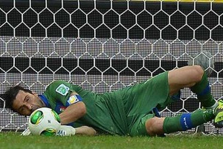 Aksi penjaga gawang Italia, Gianluigi Buffon, ketika menahan tendangan penalti pemain Uruguay, Walter Gargano, dalam drama adu penalti laga play-off perebutkan peringkat ketiga Piala Konfederasi, Minggu (30/6/2013). Italia menang 3-2 dalam adu penalti setelah mereka bermain imbang 2-2 selama 120 menit.