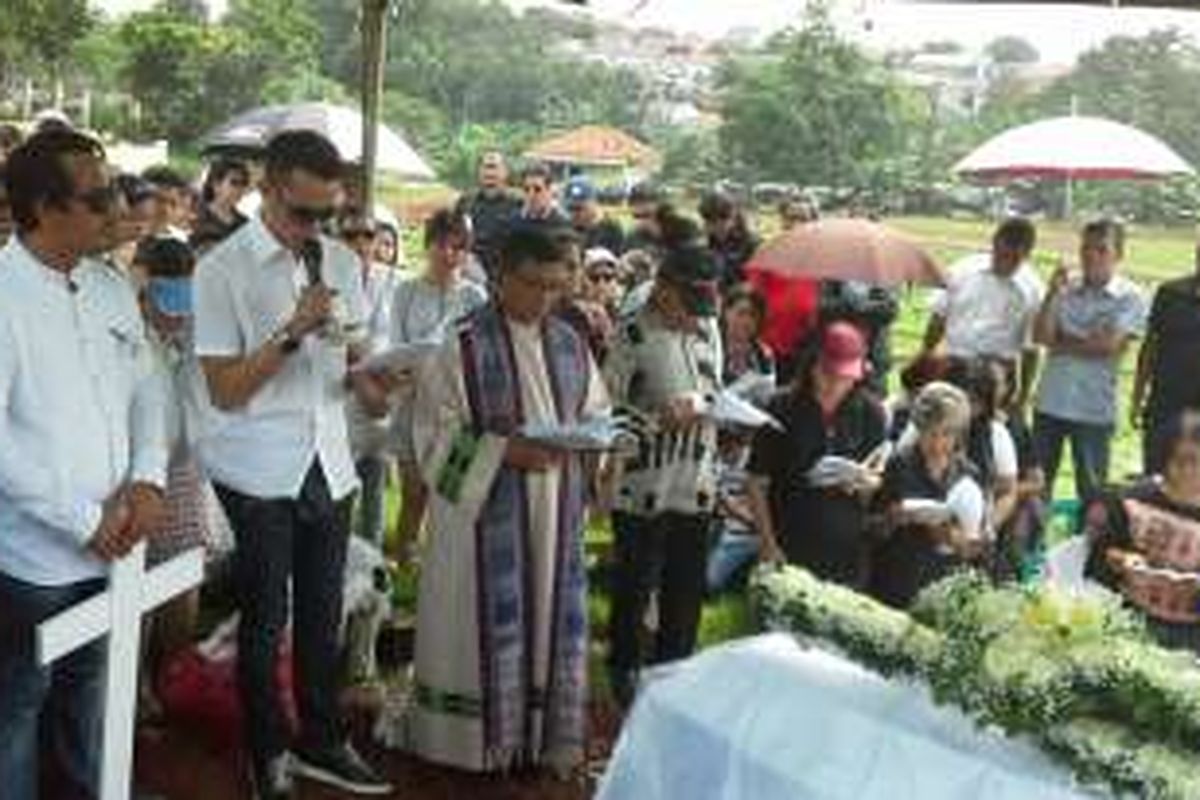 Tommy (kedua dari kiri, berkemeja putih), anak kedua Ireng Maulana, membaca doa untuk mendiang ayahnya di TPU Kampung Kandang, Ciganjur, Jakarta Selatan, Senin (7/3/2016) siang.