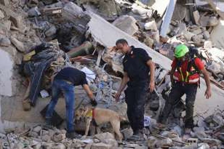 Petugas pemadam kebakaran dan penyelamat mengecek reruntuhan bangunan di Kota Amatrice setelah gempa kuat mengguncang wilayah tengah Italia itu, Rabu (24/8/2016). 