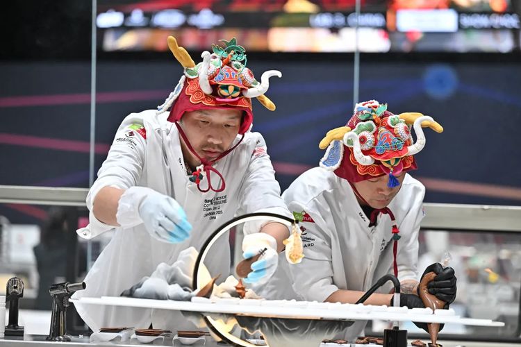 The Chinese team wore a lively head covering while working on their dessert.