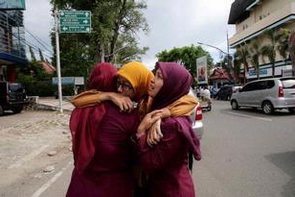 Warga Banda Aceh saling berpelukan ketika gempa bumi berkekuatan 8.5 SR mengguncang kota tersebut, Rabu (11/4/2012).
