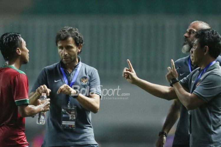 Pelatih Timnas U-23 Indonesia, Luis Milla (tengah), beserta asisten pelatih Bima Sakti (kanan) memberikan instruksi kepada Muhammad Hargianto pada laga PSSI Anniversary Cup 2018 kontra Bahrain di Stadion Pakansari, Bogor, Jumat (27/4/2018)
